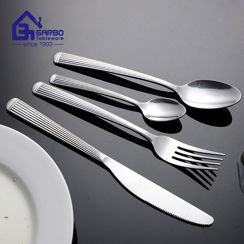 4-piece stainless steel flatware set with a line-engraved pattern handle
